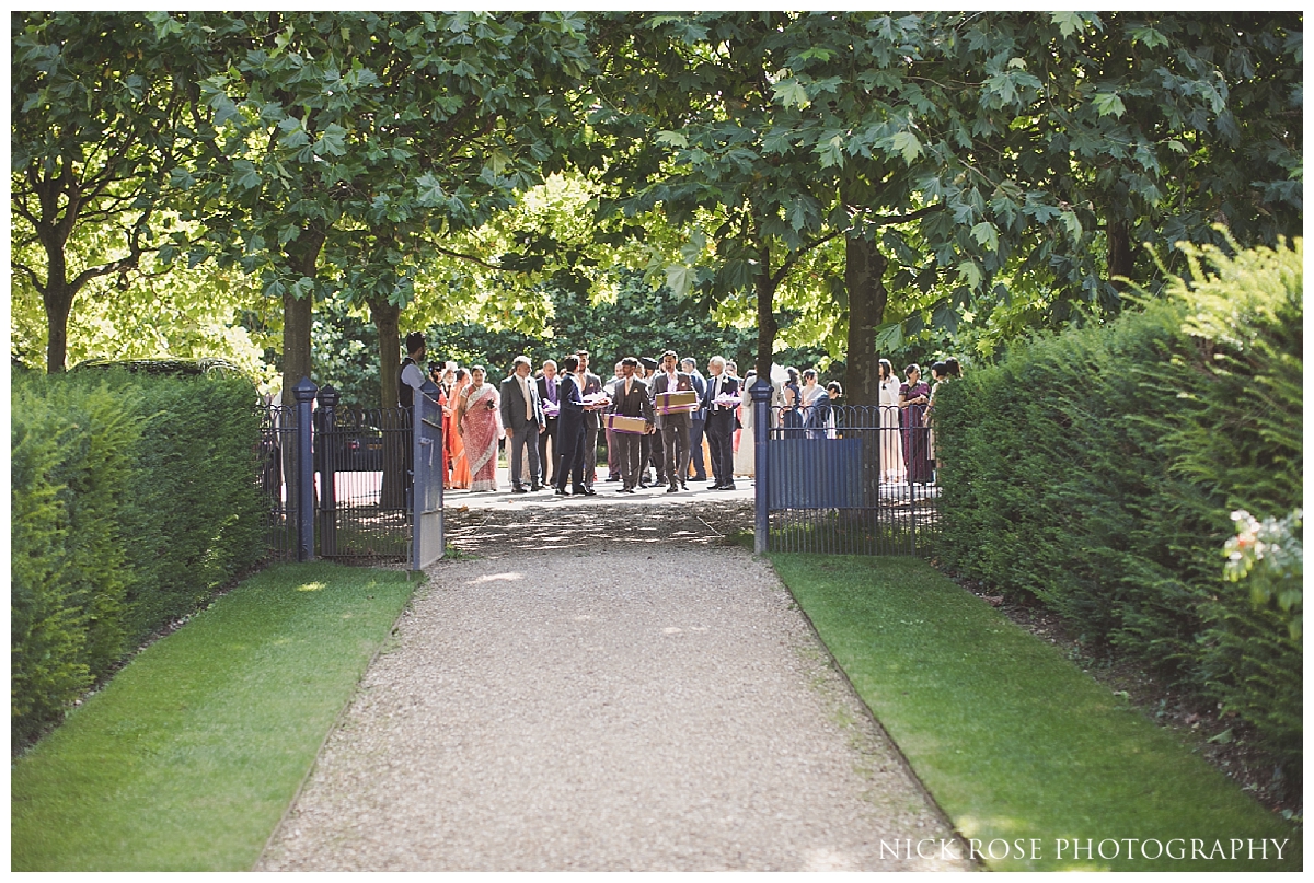 Guests arriving for an outdoor wedding reception at The Dairy in Waddesdon Manor Buckinghamshire