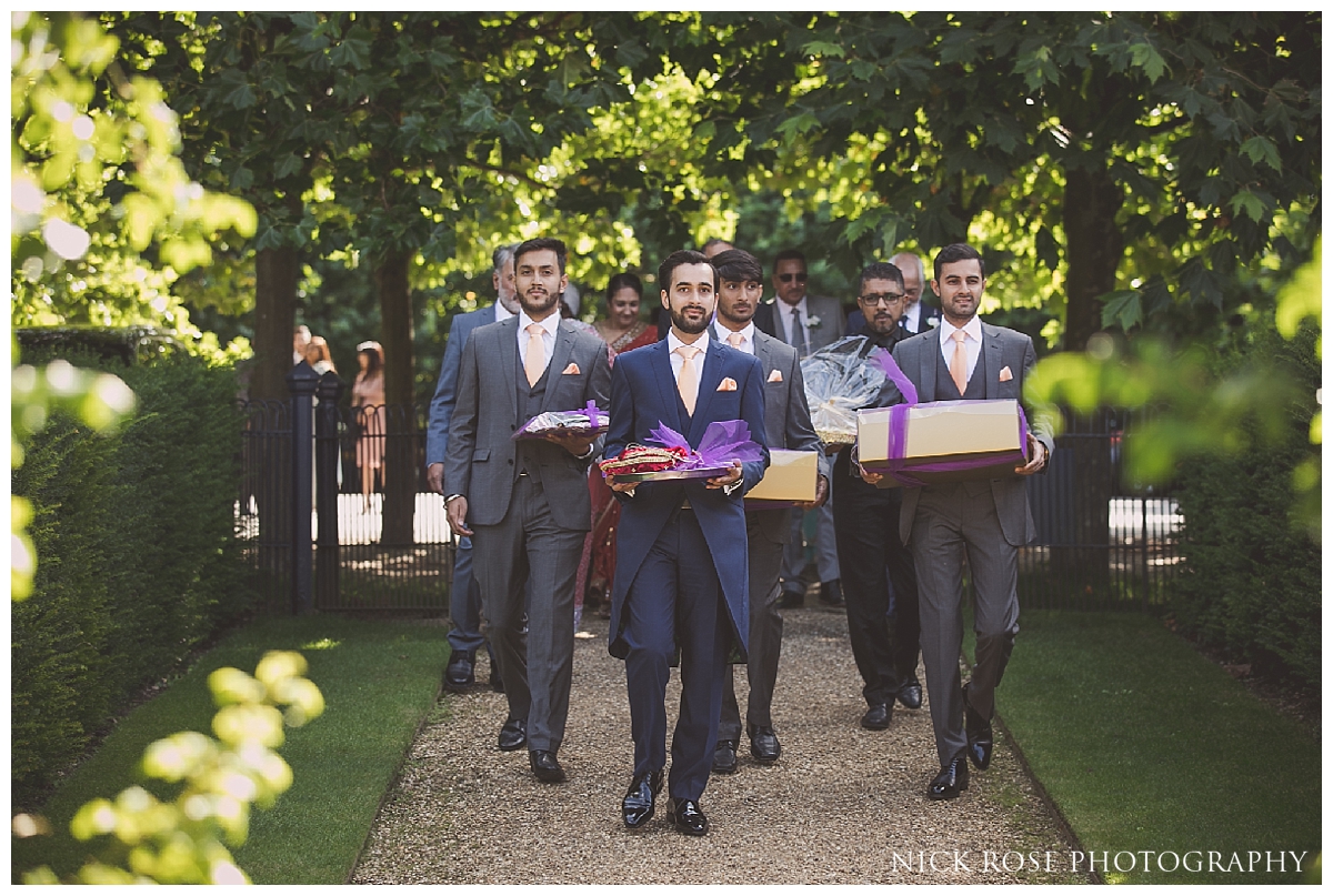  Groom and groomsmen arriving for an outdoor wedding reception at The Dairy in Waddesdon Manor Buckinghamshire 