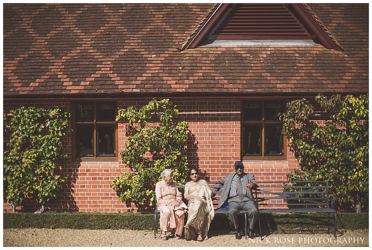 arriving for an outdoor wedding reception at The Dairy in Waddesdon Manor Buckinghamshire