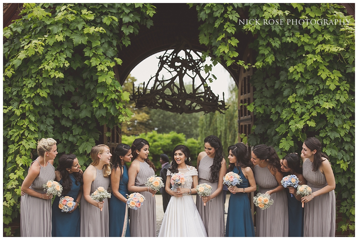 Bride with bridesmaids wearing mismatched summer dresses at The Dairy in Buckinghamshire