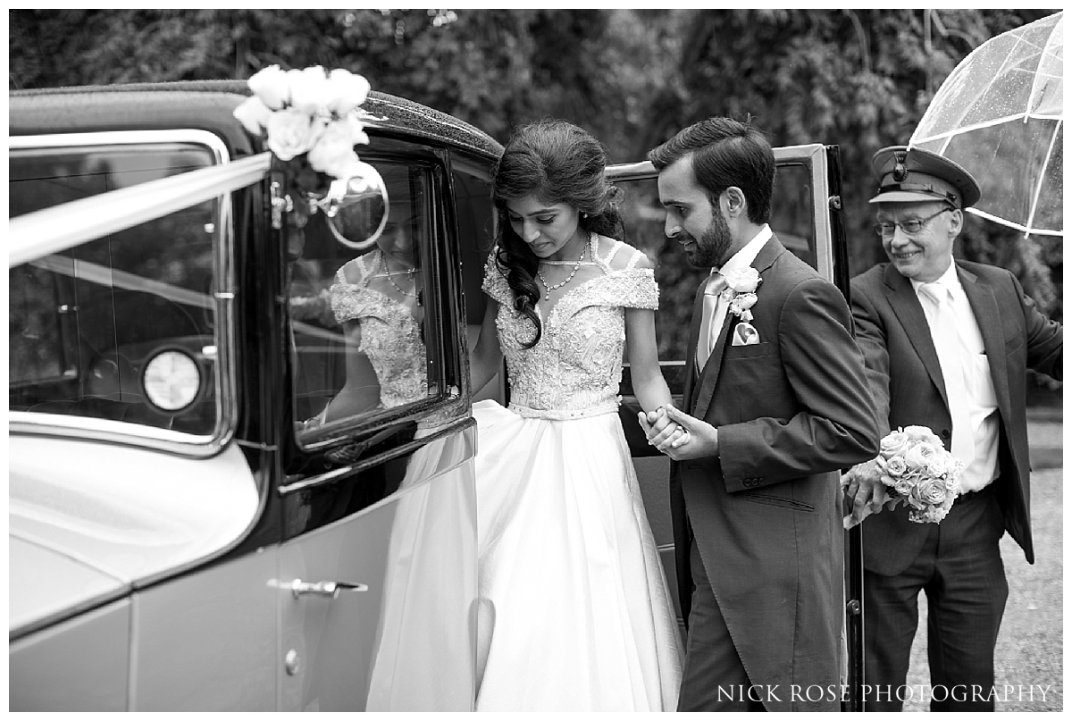  Bride and groom vintage car wedding exit from Waddesdon Manor in Bucks 