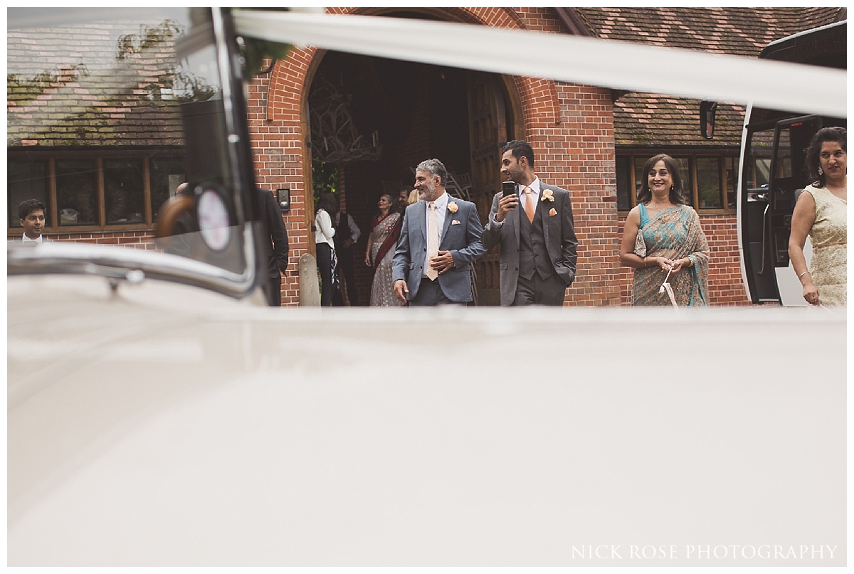 Bride and groom vintage car wedding exit from Waddesdon Manor in Bucks
