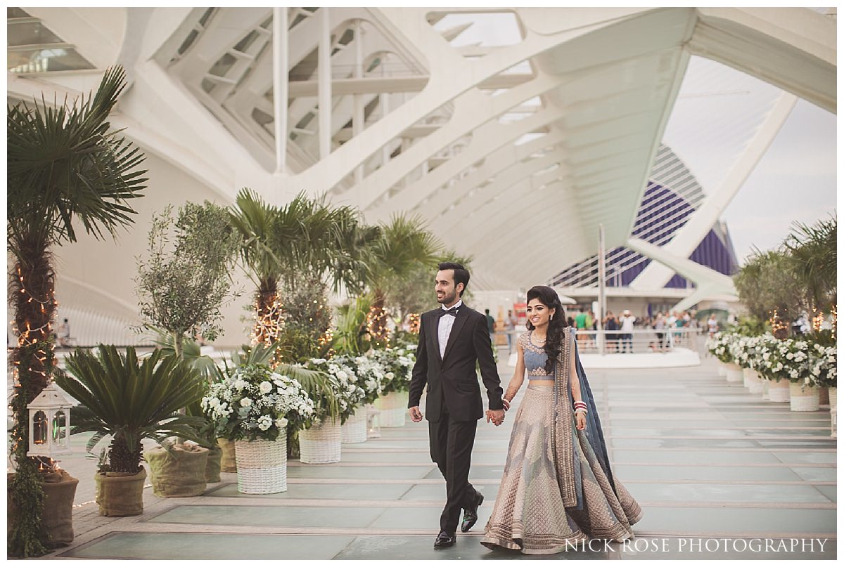  Bride and groom walking into The Hemisfèric, City of Arts in Valencia, Spain for a Sikh wedding reception 
