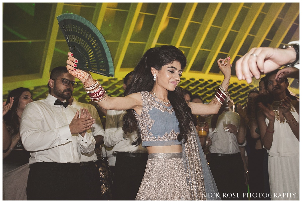 Bride dancing during a Sikh destination wedding at The Hemisfèric, City of Arts in Valencia, Spain