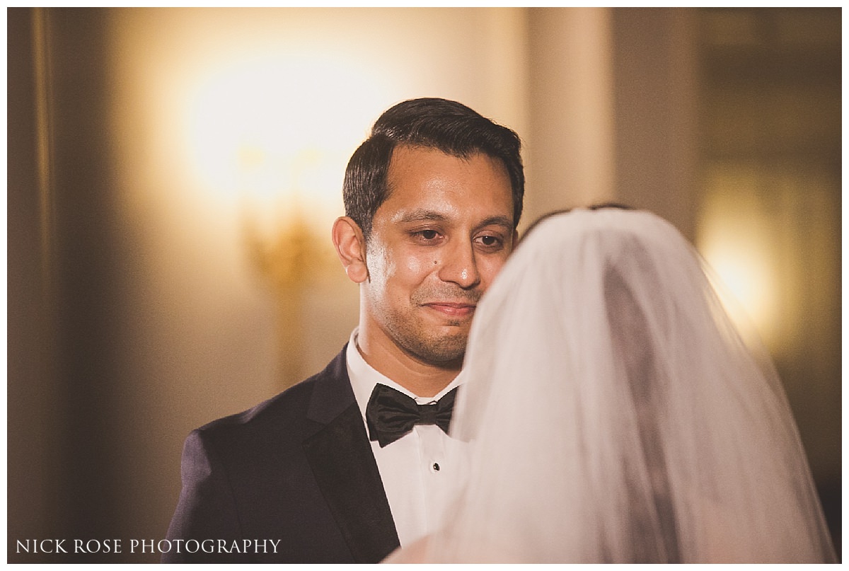  Groom looking at bride during a Savoy London wedding ceremony 