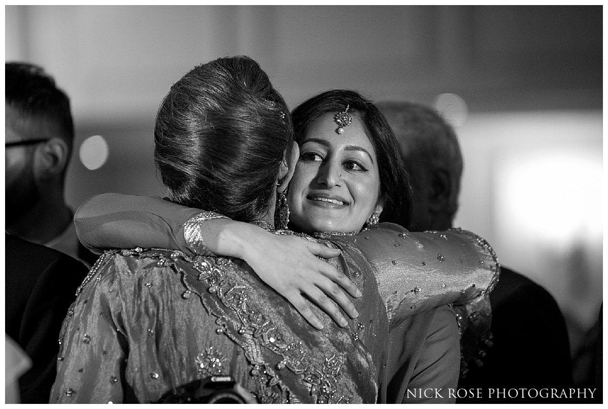  Guests hugging after a Savoy Hotel wedding in London 