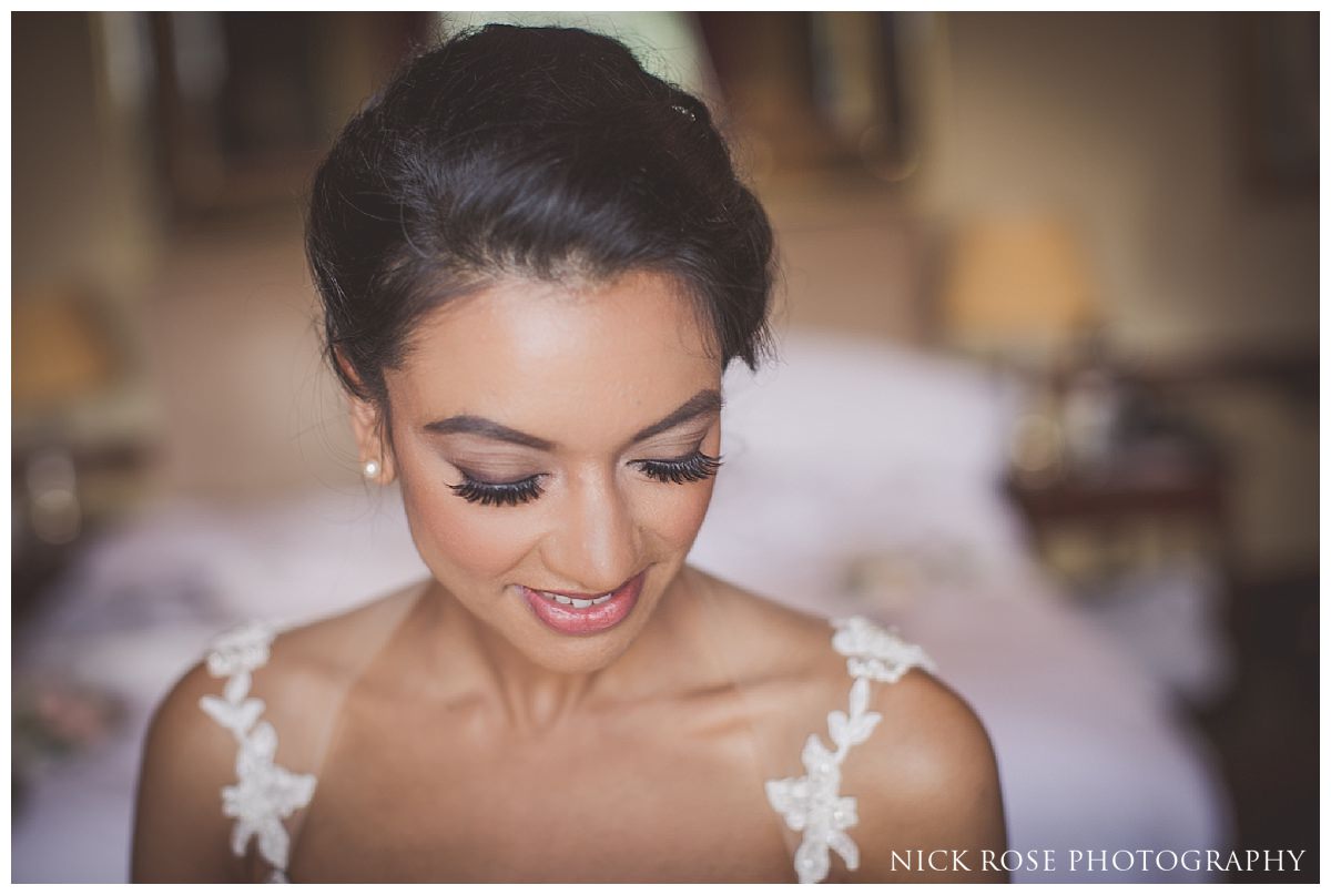  Bride getting ready for her Indian civil wedding ceremony at Stoke Park in Buckinghamshire 