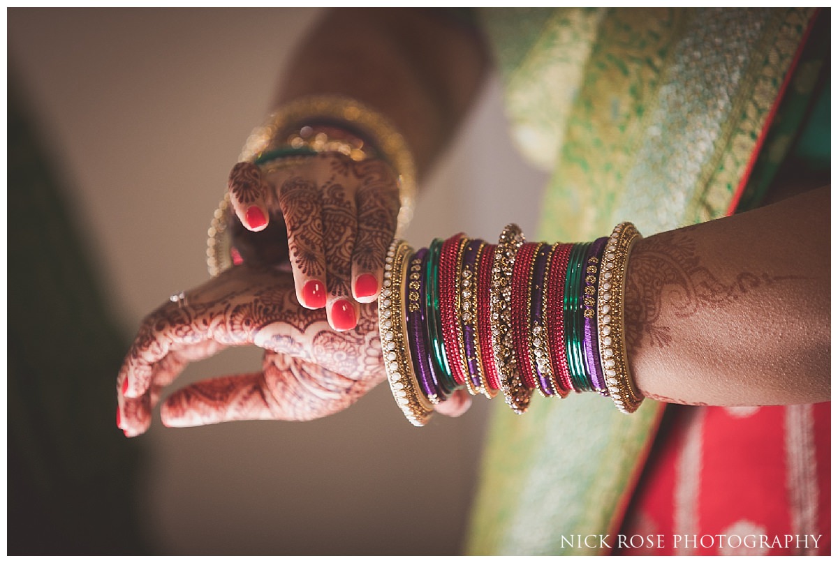 Indian bride putting on bangles before a Hindu wedding in Potters Bar