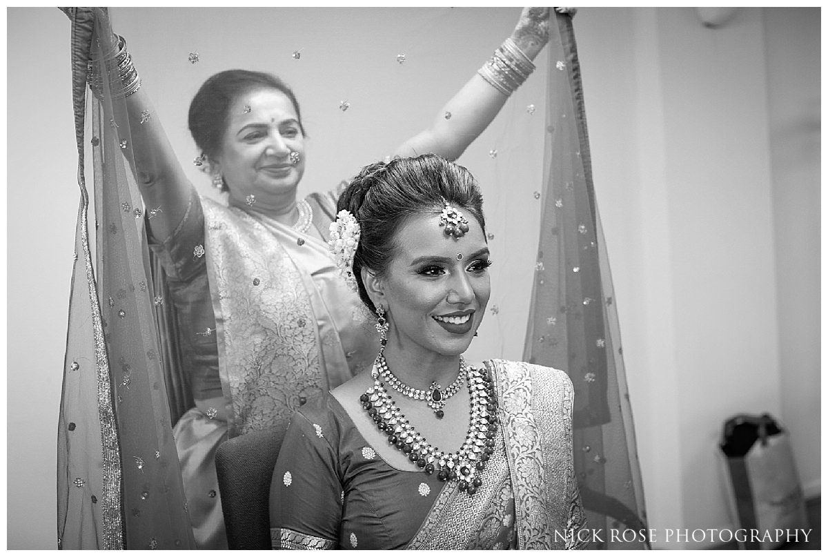 Mother putting on Chunni before a hindu wedding 