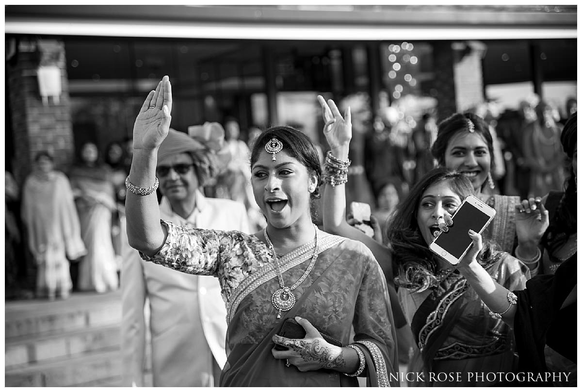  Hindu wedding baraat entrance and dancing at the Potters Bar Oshwal Centre in Hertfordshire 