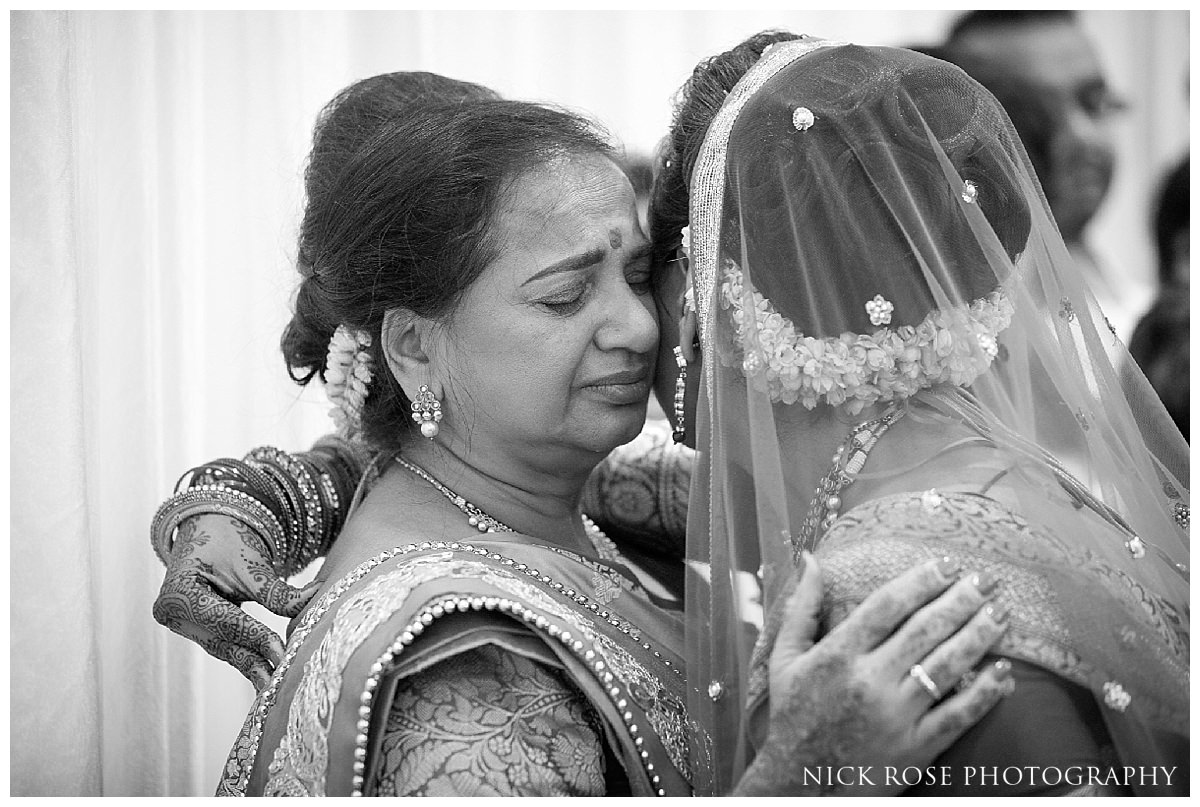  Hindu bride says goodbye to family after an Indian wedding in Hertfordshire 