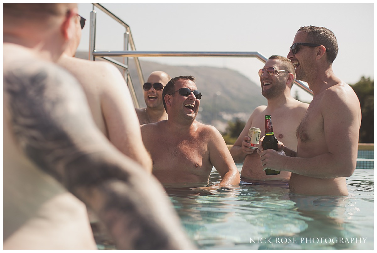  Groomsmen enjoying some drinks in the swimming pool before a Dubrovnik Palace Wedding in Croatia 