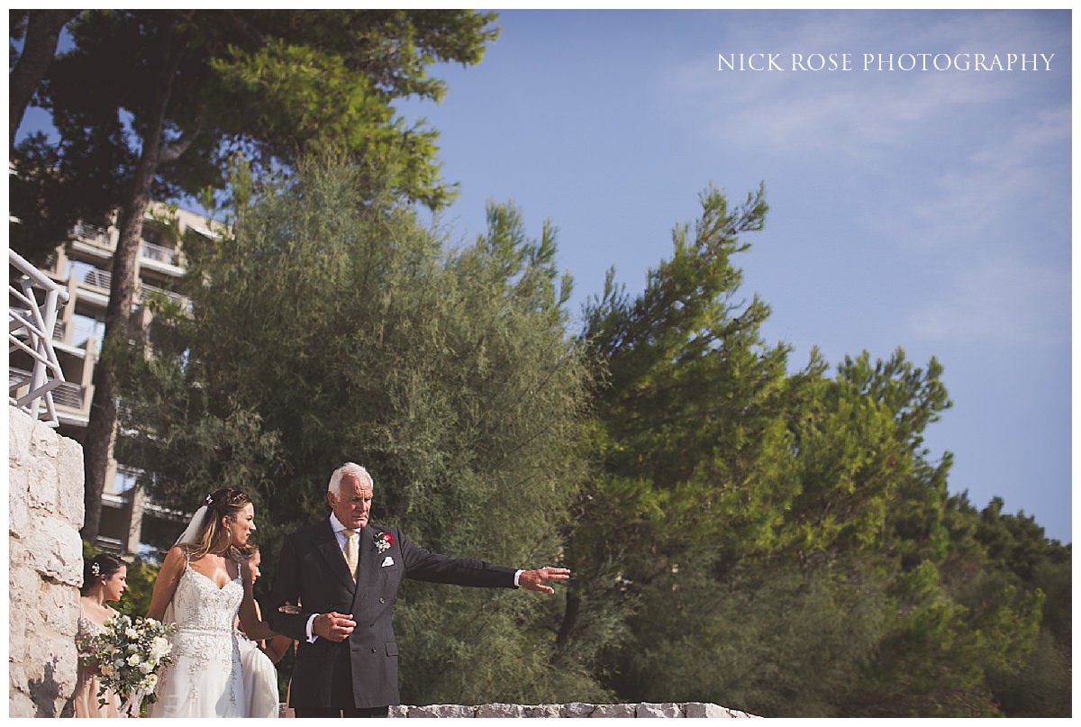  Bride walking towards the isle for a destination wedding in Croatia at Dubrovnik Palace Hotel  