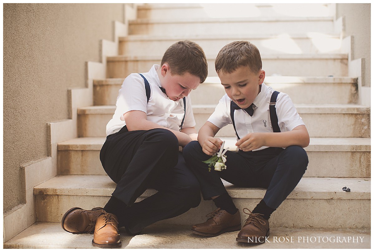  Boys sitting on the stairs at a destination wedding in Croatia at the Dubrovnik Palace Hotel 