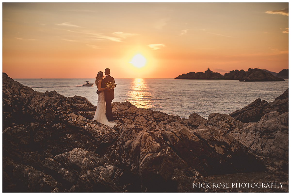  Happy couple watching the sunset with the stunning Adriatic Sea in the background for a destination wedding at Dubrovnick Palace Hotel in Croatia 