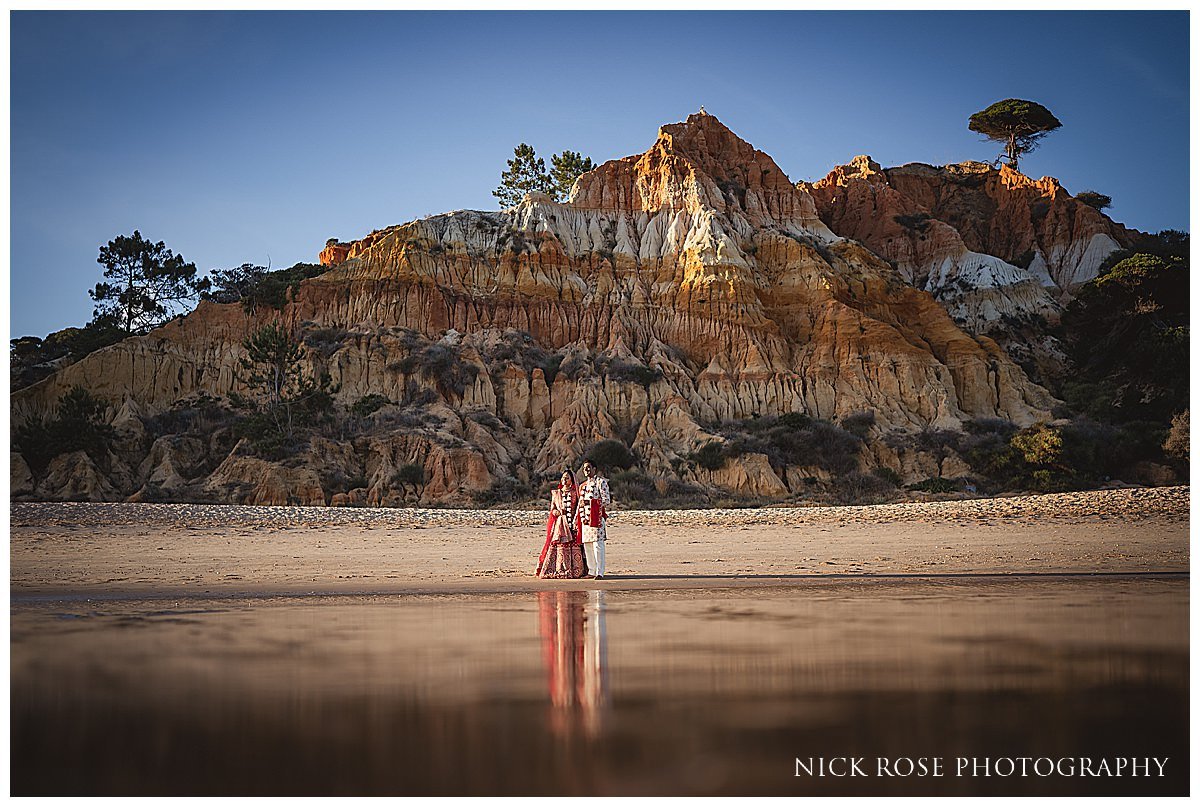  A bride and groom holding hands against a stunning ocean view at Pine Cliffs Resort in Algarve Portugal 