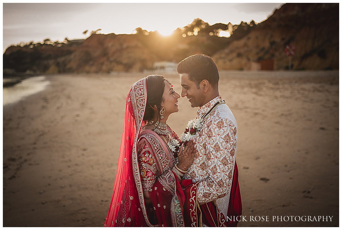  Bride and groom embracing own the beach at their destination wedding at Pine Cliffs resort in Portugal photographed by destination wedding photographer Nick Rose 