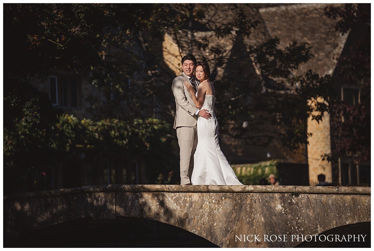  Couple sharing a tender moment on a picturesque stone bridge in Bourton-on-the-Water 