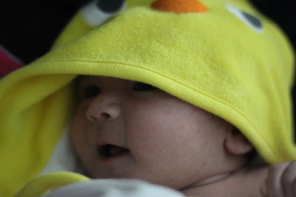 One of her many hooded towels...