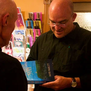David Marlett signing copies of FORTUNATE SON at a reading.