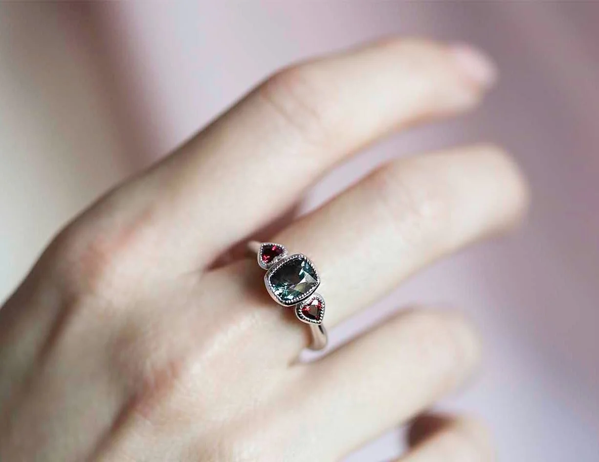 This &ldquo;BonBon&rdquo; is so so sweet you&rsquo;ll never look at sugar again 🍬A cushion cut sparkly, icy ash blue Spinel gemstone being kissed by two fiery heart shaped rubies. Fire and ice gemstones set in cool contemporary 18ct solid white gold. Tap the image for more info about this one off design, or come try it on instore✨
.
.
#ruby #rubies #rubyring #spinel #designerring #rarejewellery #ringoftheday #couture #bespoke #strandarcade #australiangold