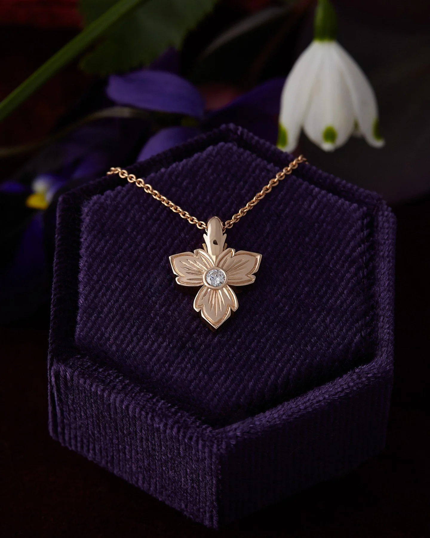 Through you, life blooms 
I like to wear little reminders of my cottage garden , when I can’t be digging in it , enjoying these spring treasures . 
This Trillium hand engraved pendant is double sided , with a diamond and gemstone on the revers