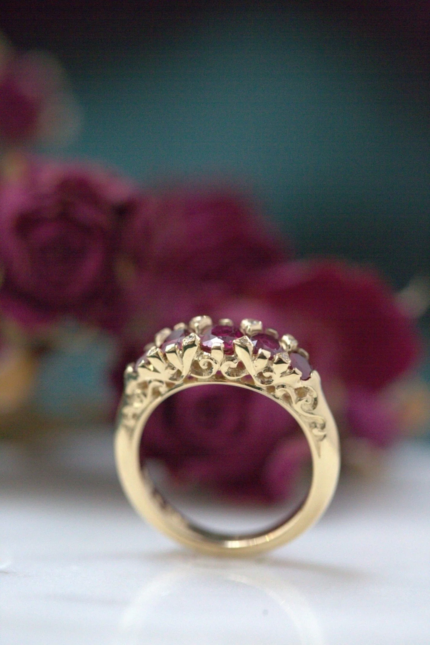 This vintage style engagement ring  was commissioned by a client back in 2015 , after her original Victorian ring in this classic 5 gem style  got too worn out to repair . We kept the  visual refinement but made the overall gold structure much heavie