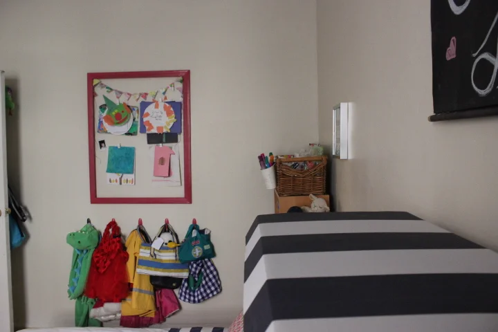 A kid's art gallery, art center and dress up wall.