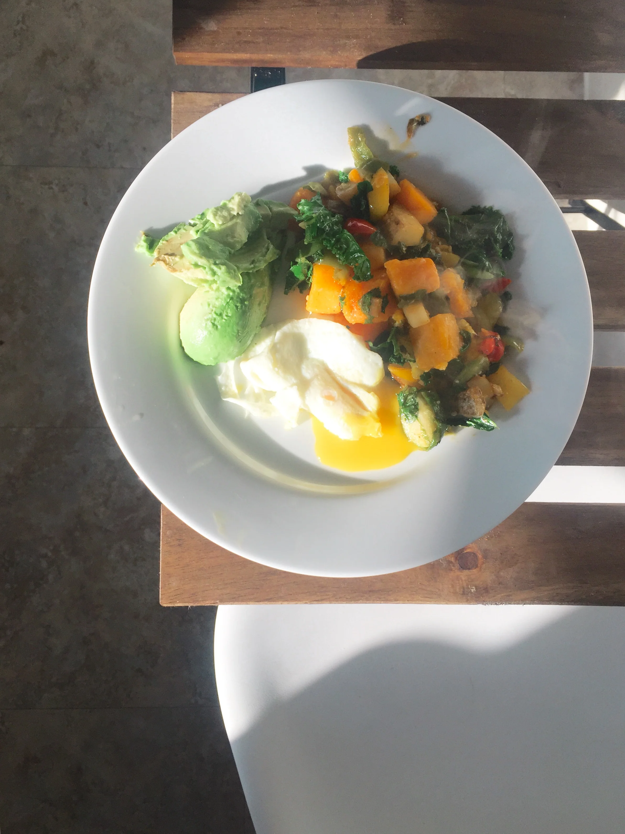 Butternut squash, potato, peppers, and kale with eggs and avocado