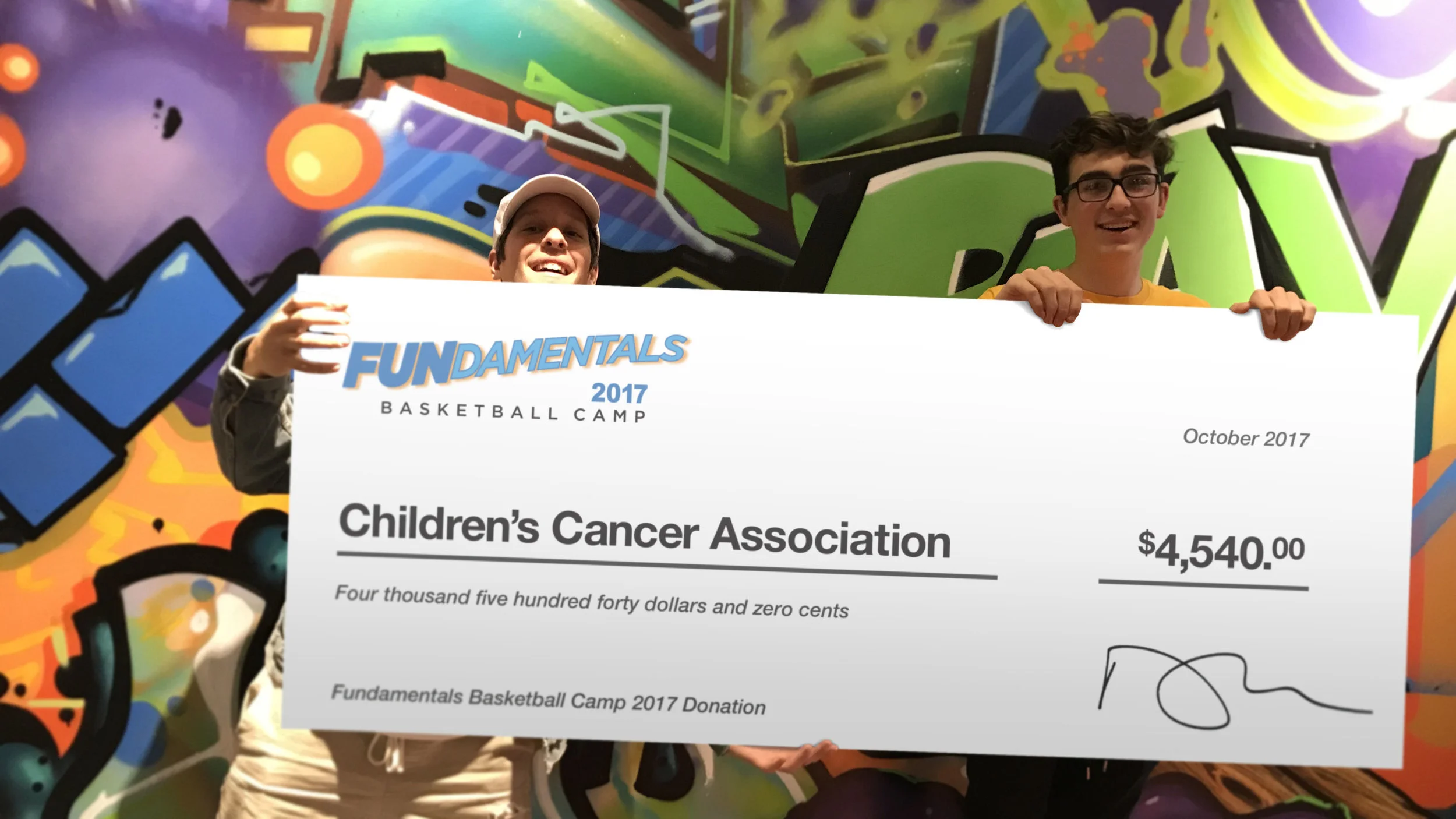 Jake Mount (right) and John at CCA presenting over $4,500 from the proceeds of FUNdamentals Basketball Camp 2017.