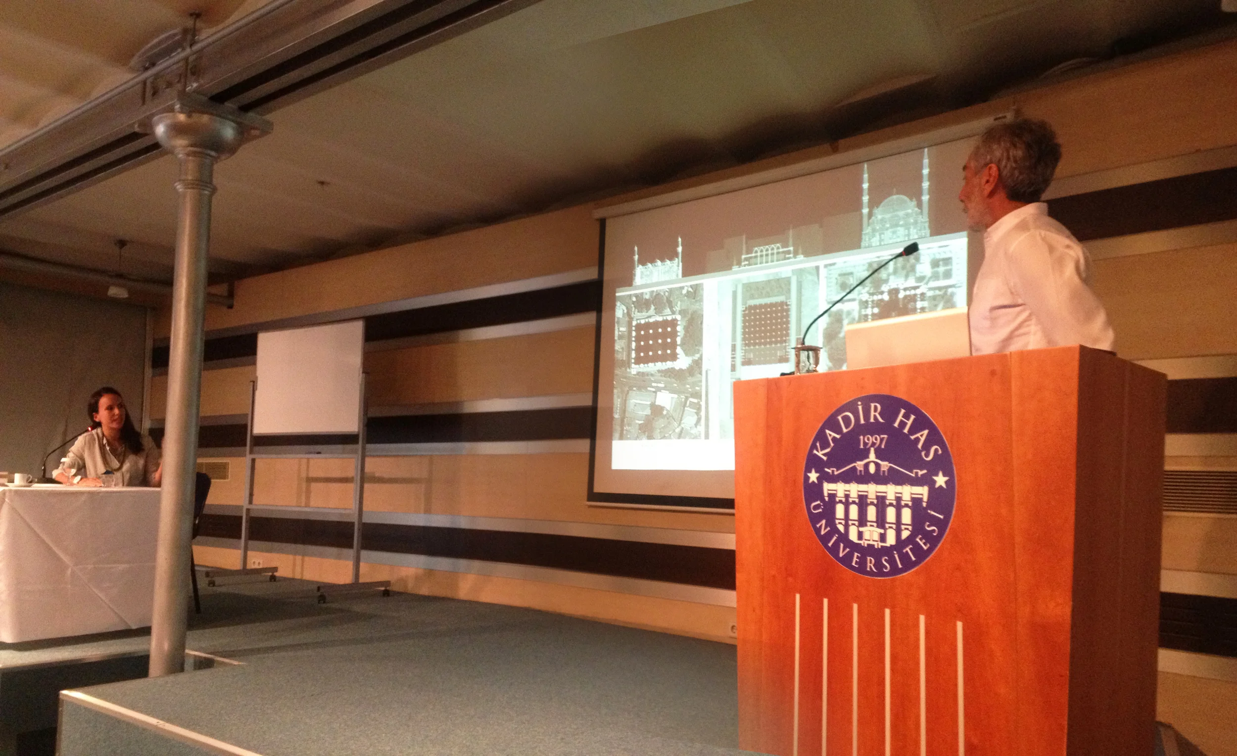 Seher simultaneously translating the architect Nevzat Sayın's lecture from Turkish to English