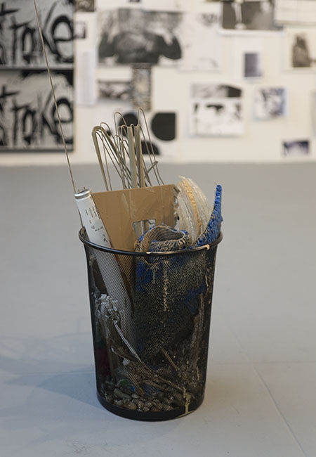   A.K. Burns &amp; Katherine Hubbard,   In spirit of (a major in women’s studies) , 2014. Mesh waste basket, leather studded belt, florescent light bulb, coat hangers, rose made of feathers, ruler, triangle, bottle of goo gone, electrical power strip