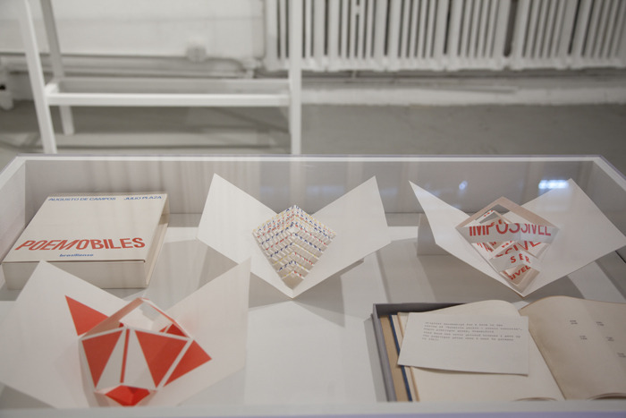   Bibi Calderaro,   Piece with No Name,  2011. Installation of a notebook (recycled paper, velum, recycled cardboard, and plastic spiral), 2 industrial fans, table, air, and electricity. 