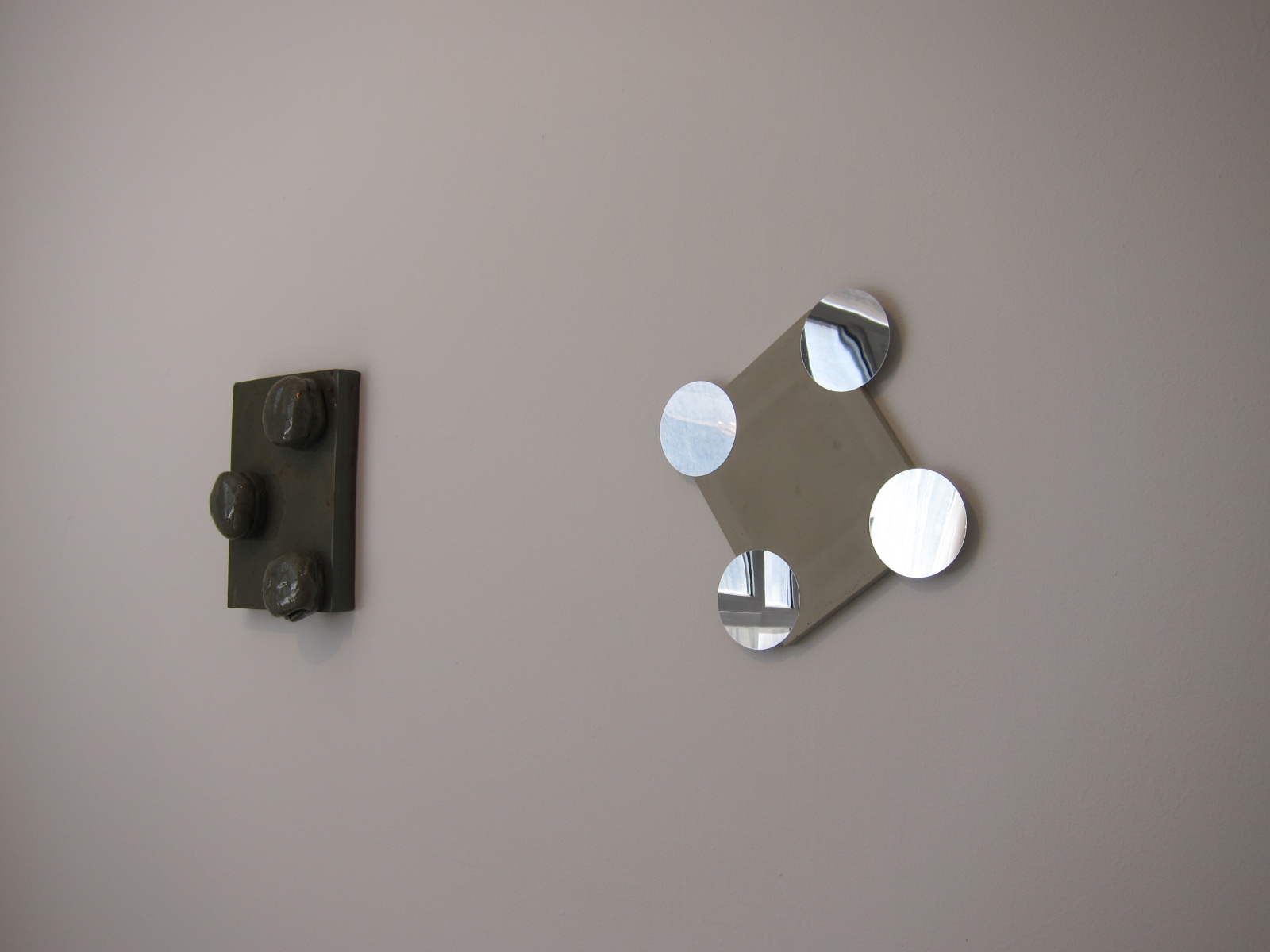  Right:   Mamiko Otsubo,   Untitled (Polka Dots VII) , 2013  Concrete, mirror polished stainless steel.  Left:  Untitled (Burger Polka Dots) , 2013. Glazed ceramic. 
