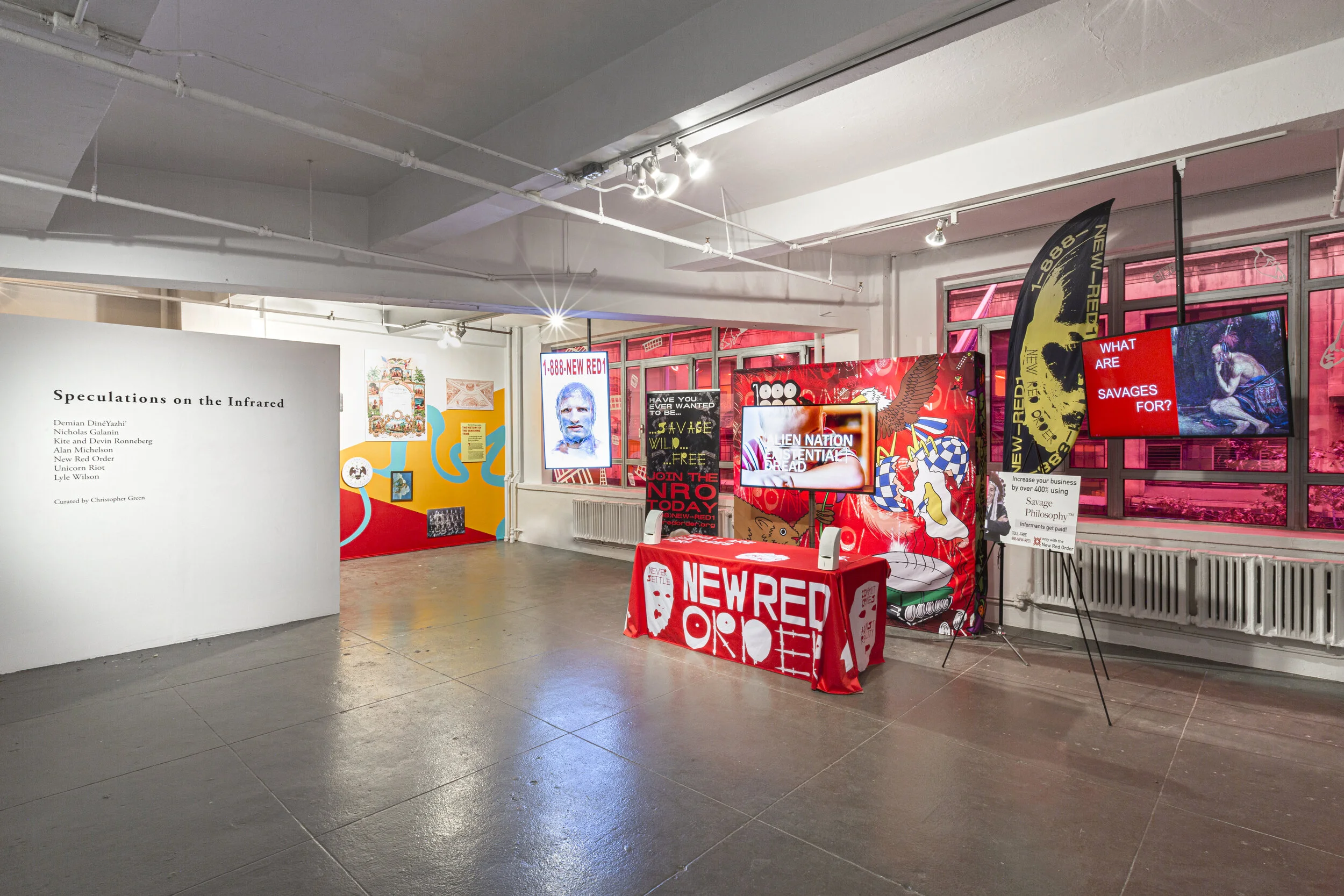 New Red Order, Never Settle, 2018-ongoing. Digital video. 49:32. Recruitment Station, 2020-21, with Gaile Pranckunaite, Inpatient Press, and Emmett de Muzio. Nylon banners, polyester table cloth, foam board, video monitors, cut white vinyl o