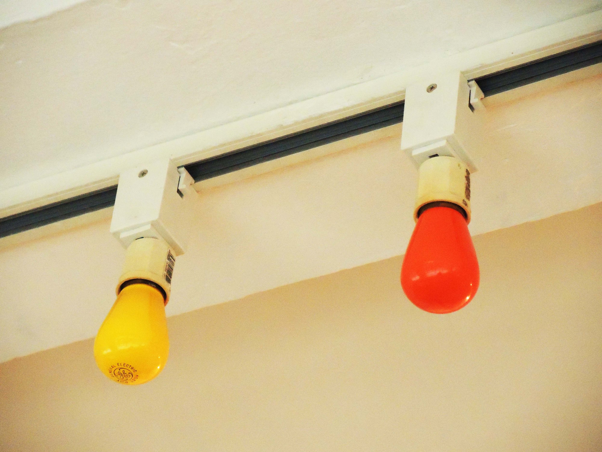 Electrical track adaptors with socket adaptors with light bulbs. 