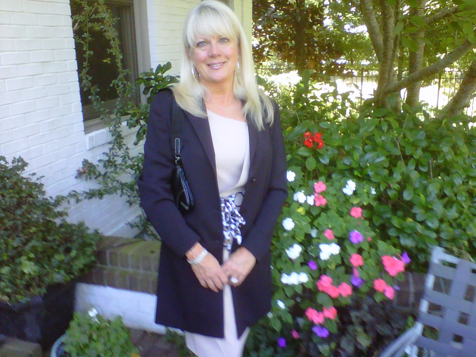 The philosophical lady of the house, married to the other philosopher for forty five years, is here paused from nearly constant motion and standing momentarily beside a small splash of her many flowers. When Tom is traveling, or is in nearly monastic isolation while writing, she'll make sure your message gets through to him.