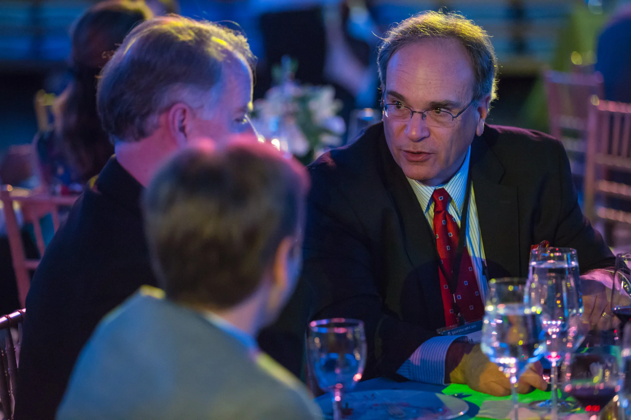 Tom at dinner, talking philosophy and life in the Dean Smith Center, "The Dean Dome" UNC Chapel Hill, down on the floor, center court, where there was no game, no foul, but great fish and wine. The Morehead-Cain Alumni Forum, October 10, 2016.