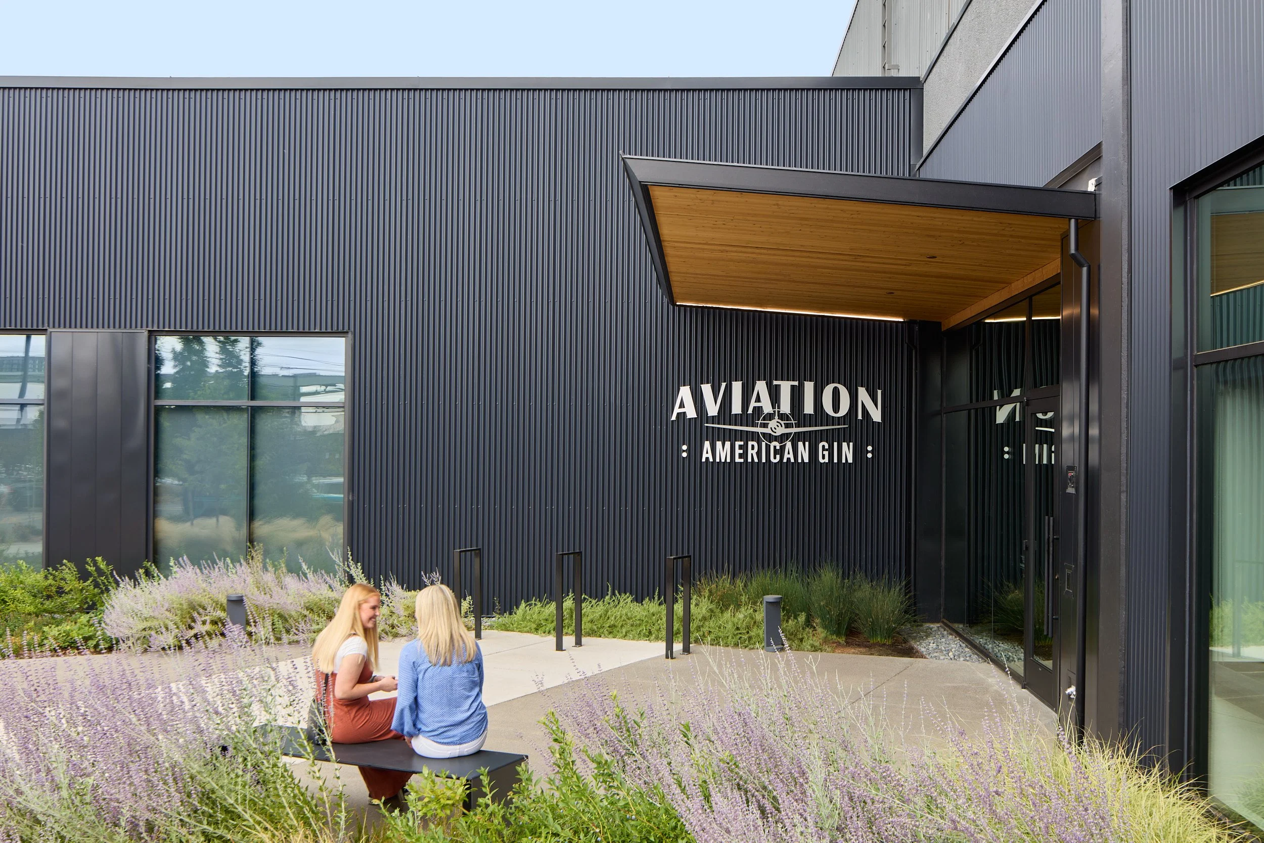 Exterior architectural detail image of the Aviation Gin Distillery entrance, seating, and landscape design, capturing visitor experience in Portland, Oregon.