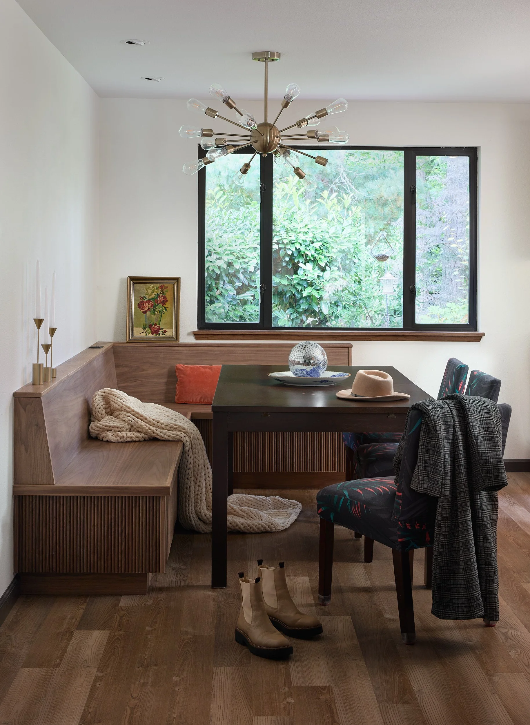 MCM dining room in Olympia, WA, with custom pendant lighting, built-in storage seating, and original wood flooring by Brown Building Contractors.