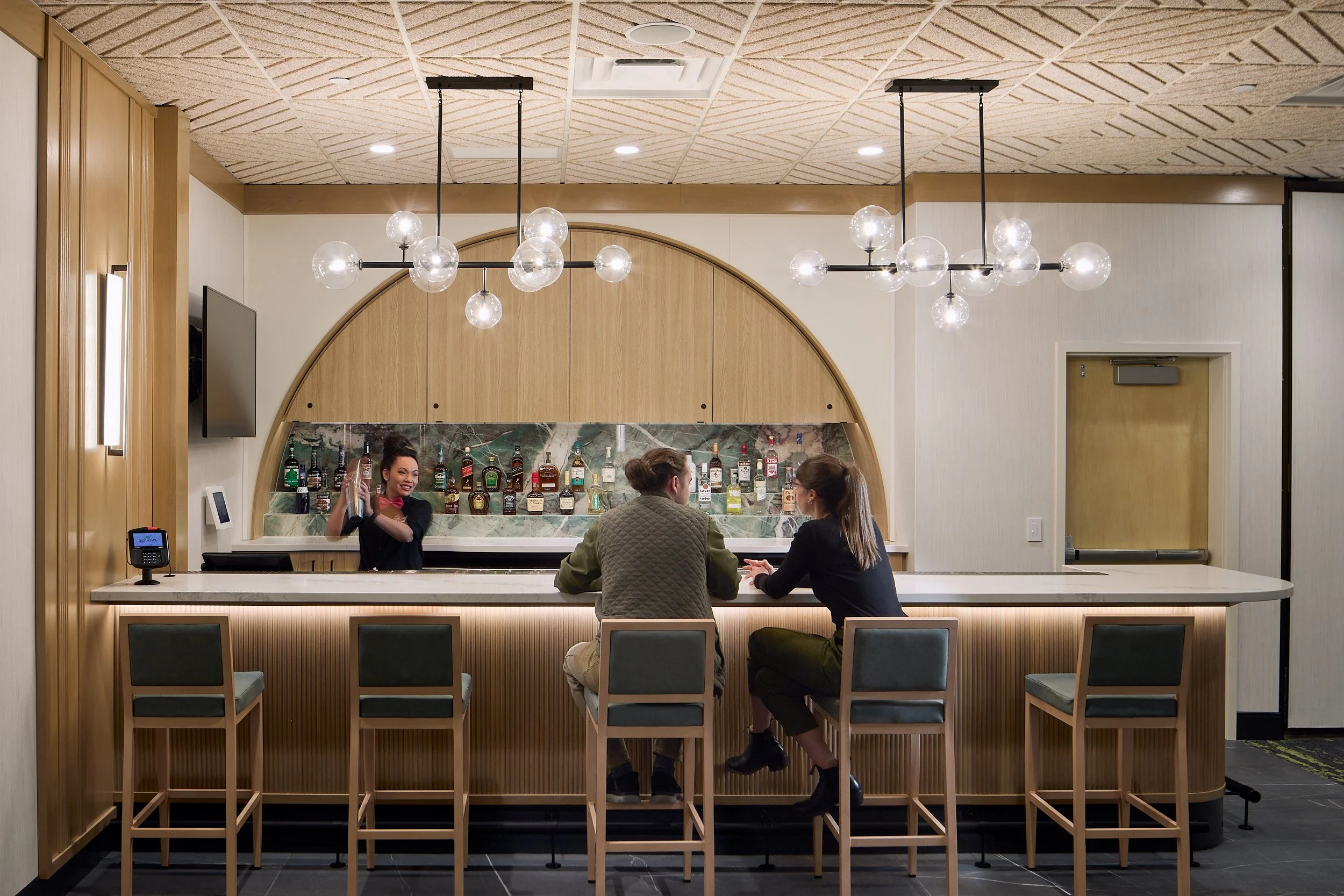 Interior architectural detail of the Salmonberry Event Center wet bar, capturing bartender service and guest experience at Nisqually Red Wind Casino, designed by Rice Fergus Miller.