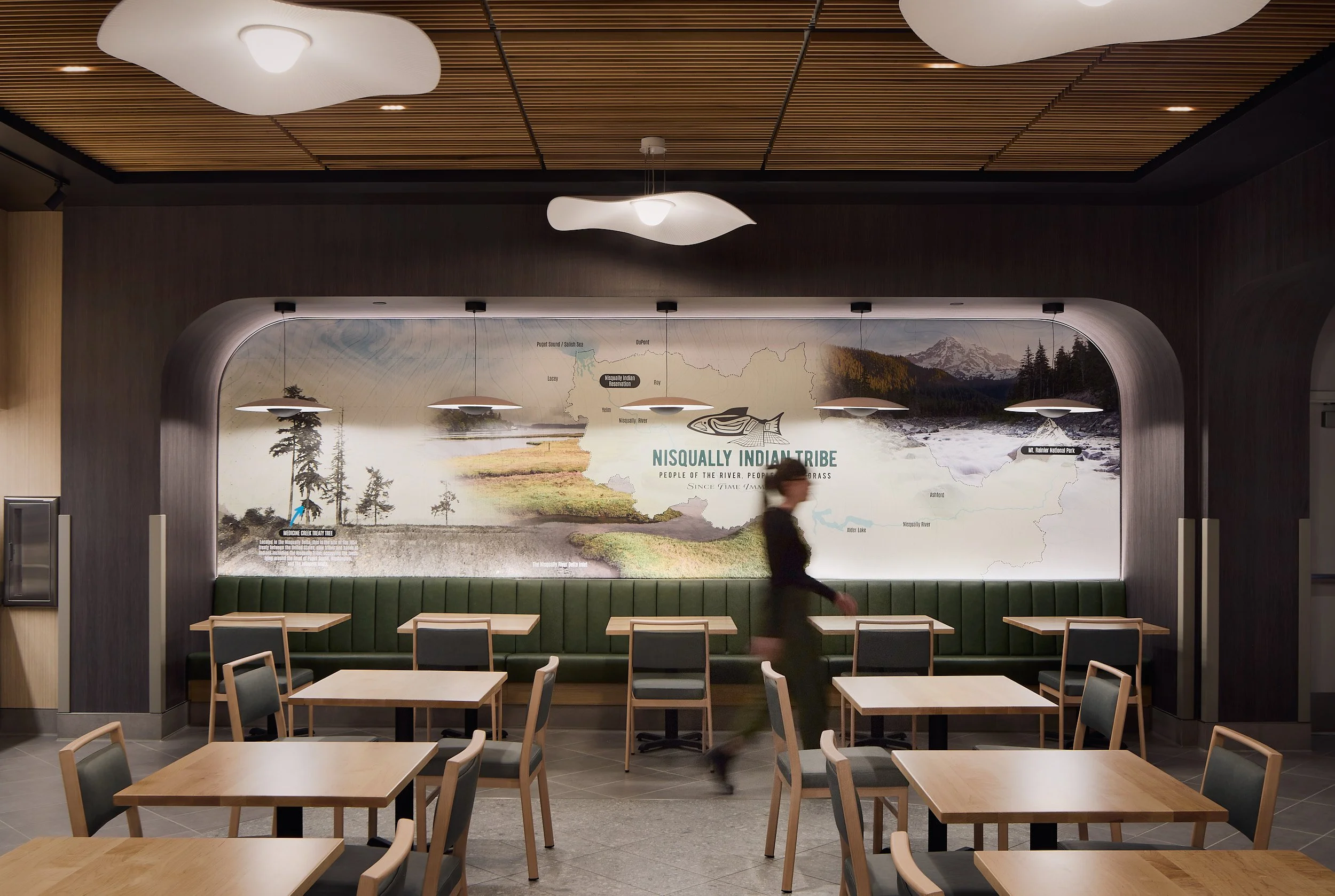 Interior architectural detail image showcasing native artwork and cultural design elements in the back seating area of The Delta Food Hall at Nisqually Red Wind Casino, designed by Rice Fergus Miller.