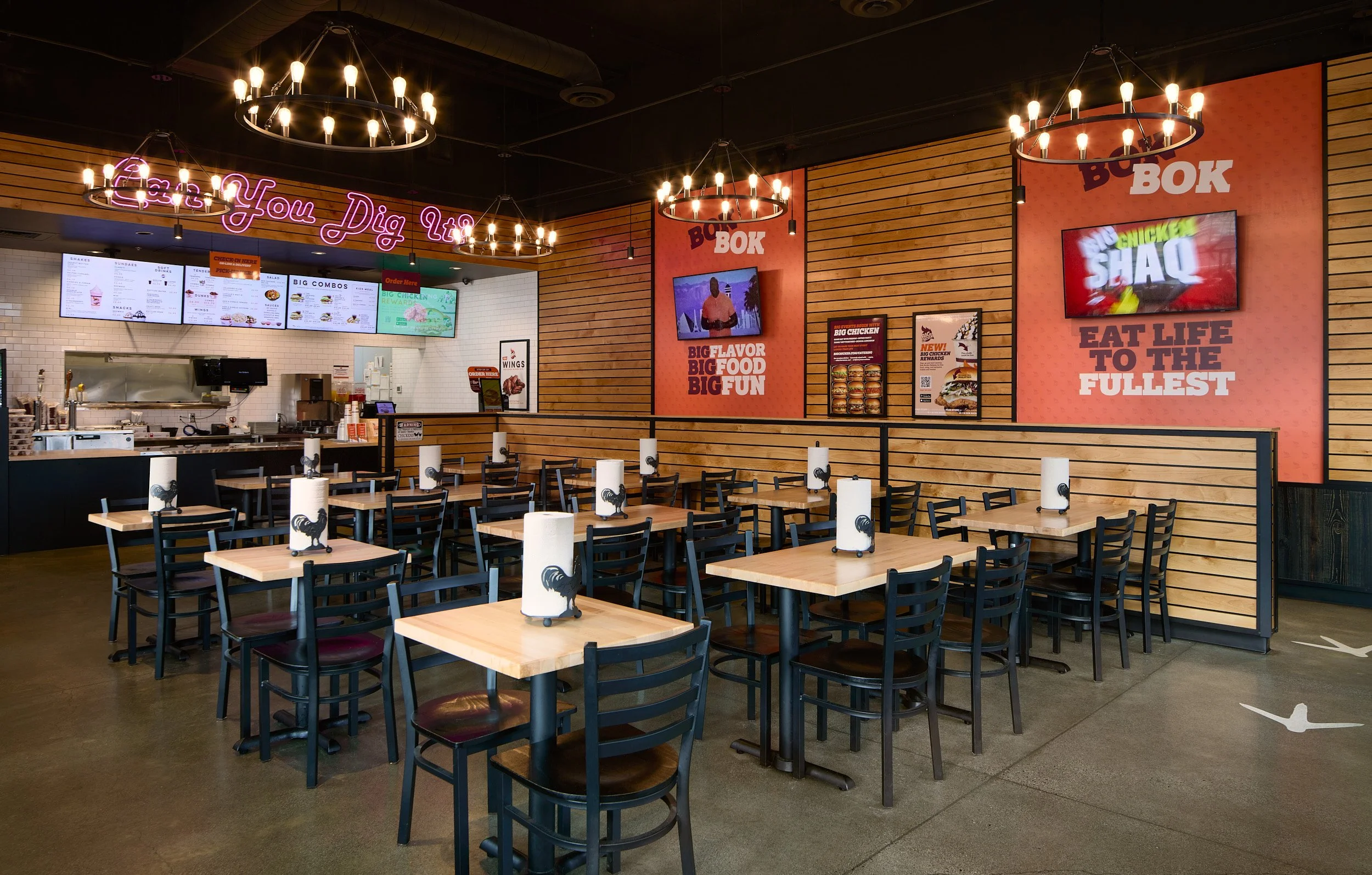 Interior architectural photography of the Shaquille O'Neal-owned Big Chicken quick-service restaurant dining area in Shoreline, Washington, designed by Sue Genty Interior Design.