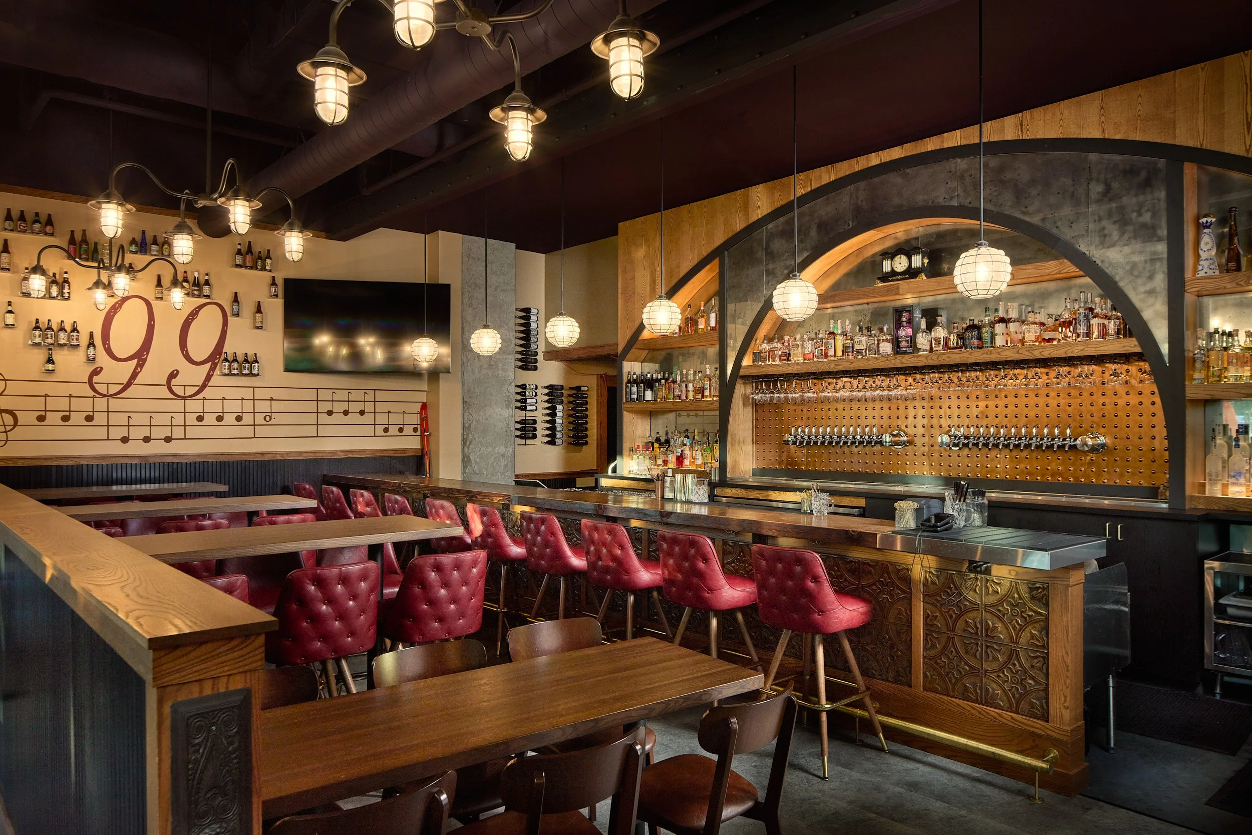Interior architectural photography showcasing the main bar and taproom area at Side Hustle Local in Bothell, Washington, featuring custom millwork and bar design by Sue Genty Interior Design.