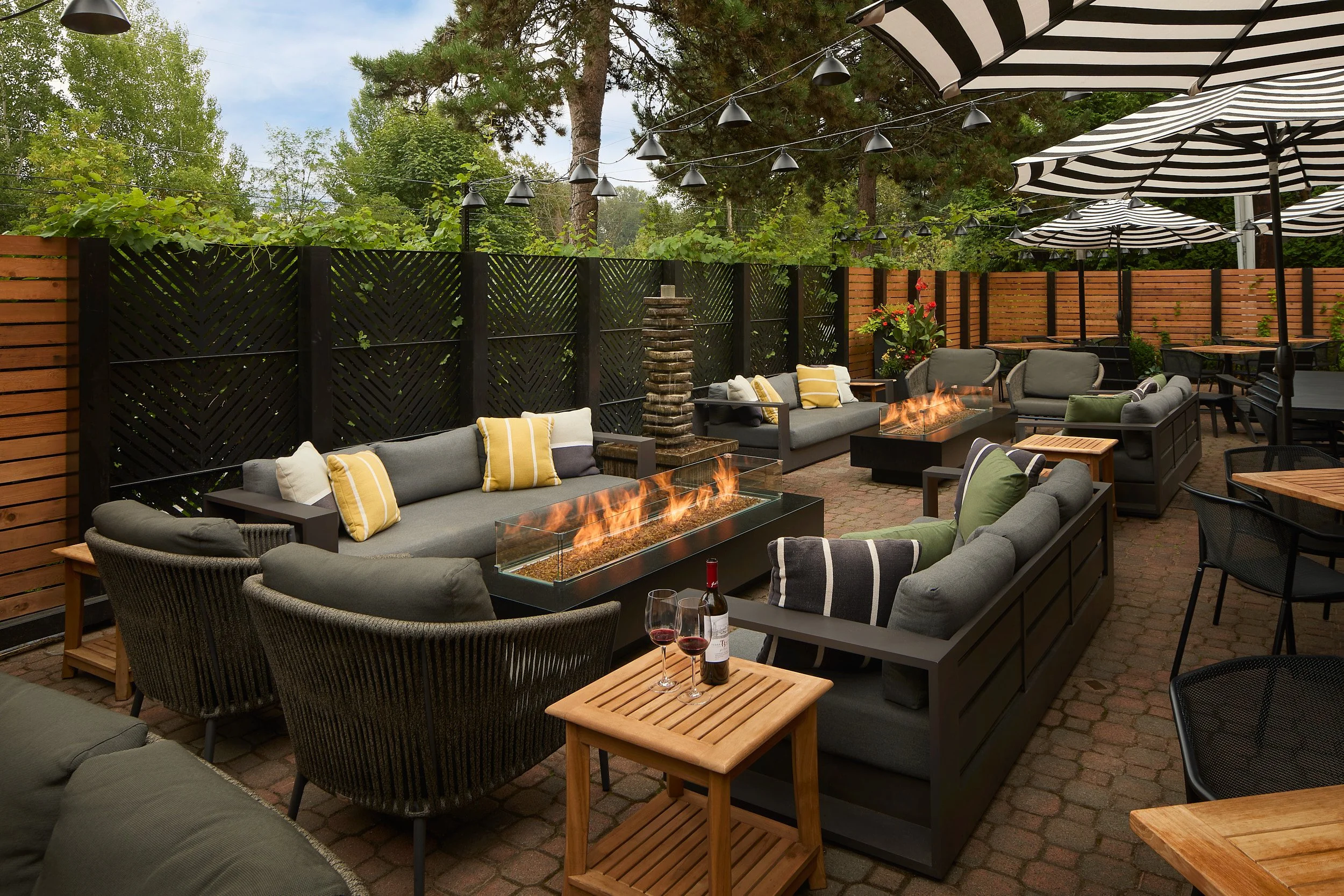 Exterior architectural photography showcasing the Vons 1000-Spirits restaurant and bar outdoor patio seating area in Woodinville, Washington, designed by Sue Genty Interior Design.