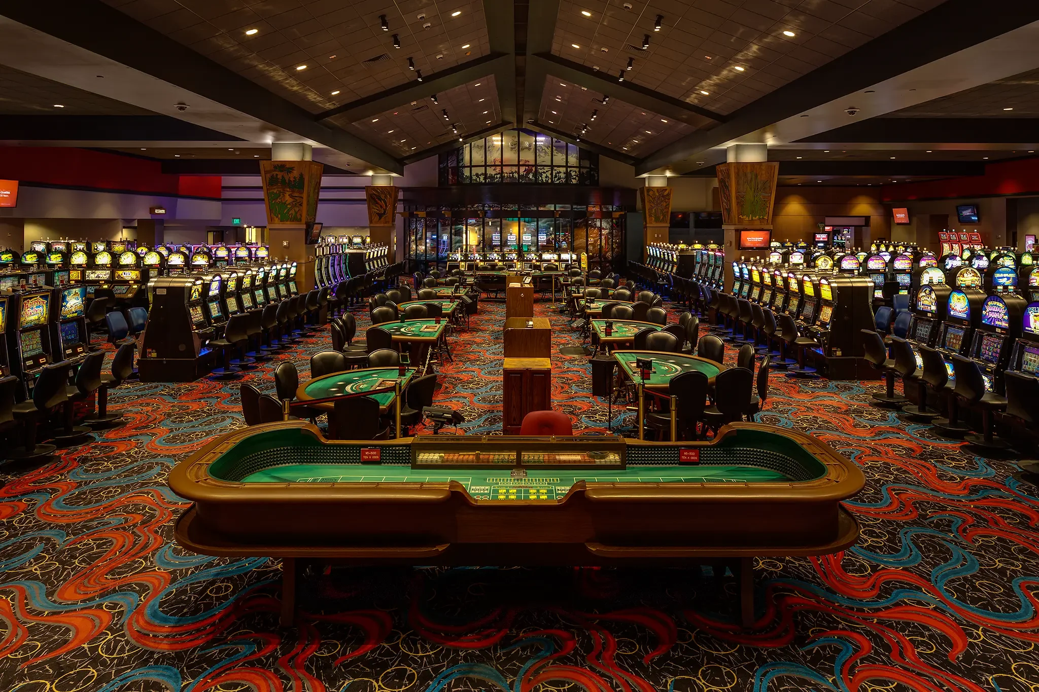 Long architectural view of the Nisqually Red Wind Casino floor, highlighting the craps table and gaming design by KMB Architects.