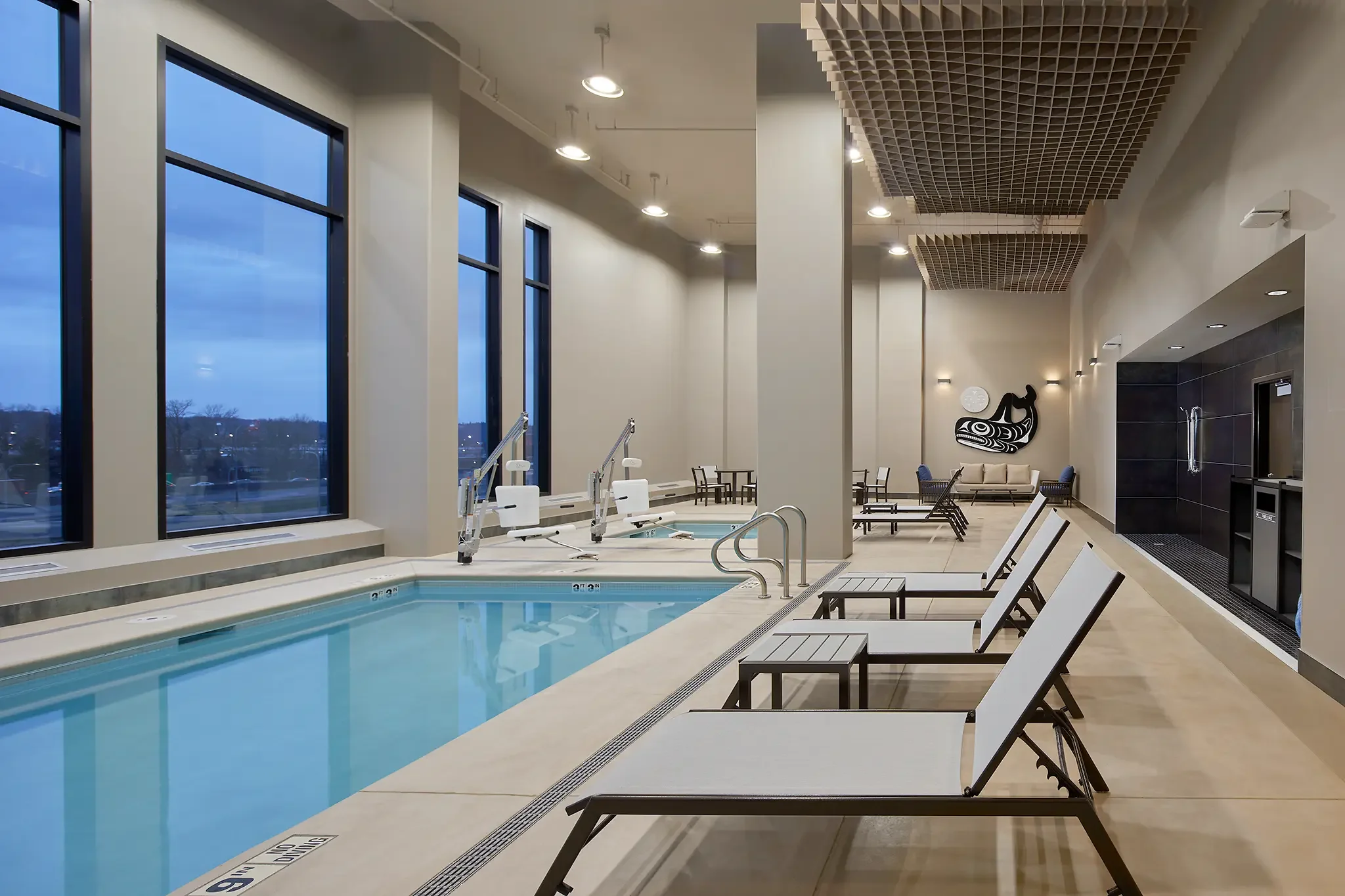 Indoor pool area and aquatic facility design inside the Emerald Queen Casino project in Tacoma, Washington, by Cuningham Architects.