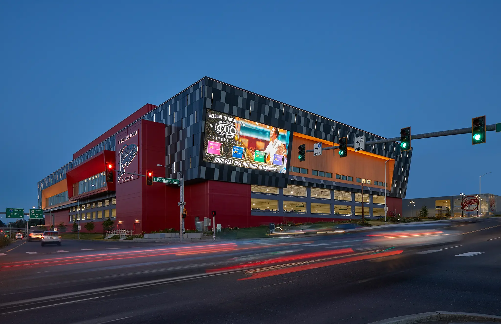 Twilight image of the grand Emerald Queen Casino exterior facade, Tacoma, WA, designed by Cuningham Architects.