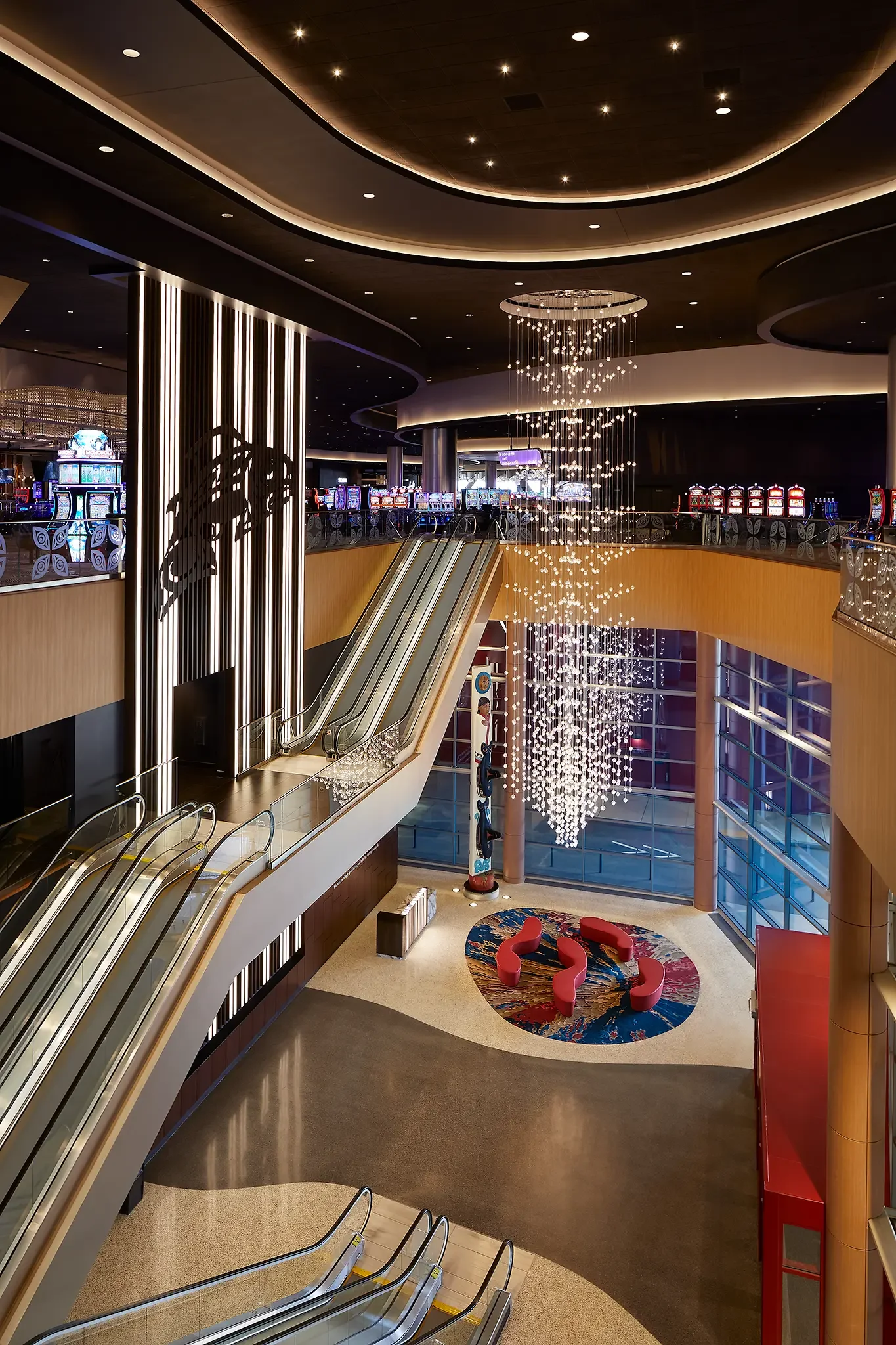 High-level sweeping view of the casino lobby and lighting feature at Emerald Queen Casino, Tacoma, WA, designed by Cuningham Architects.