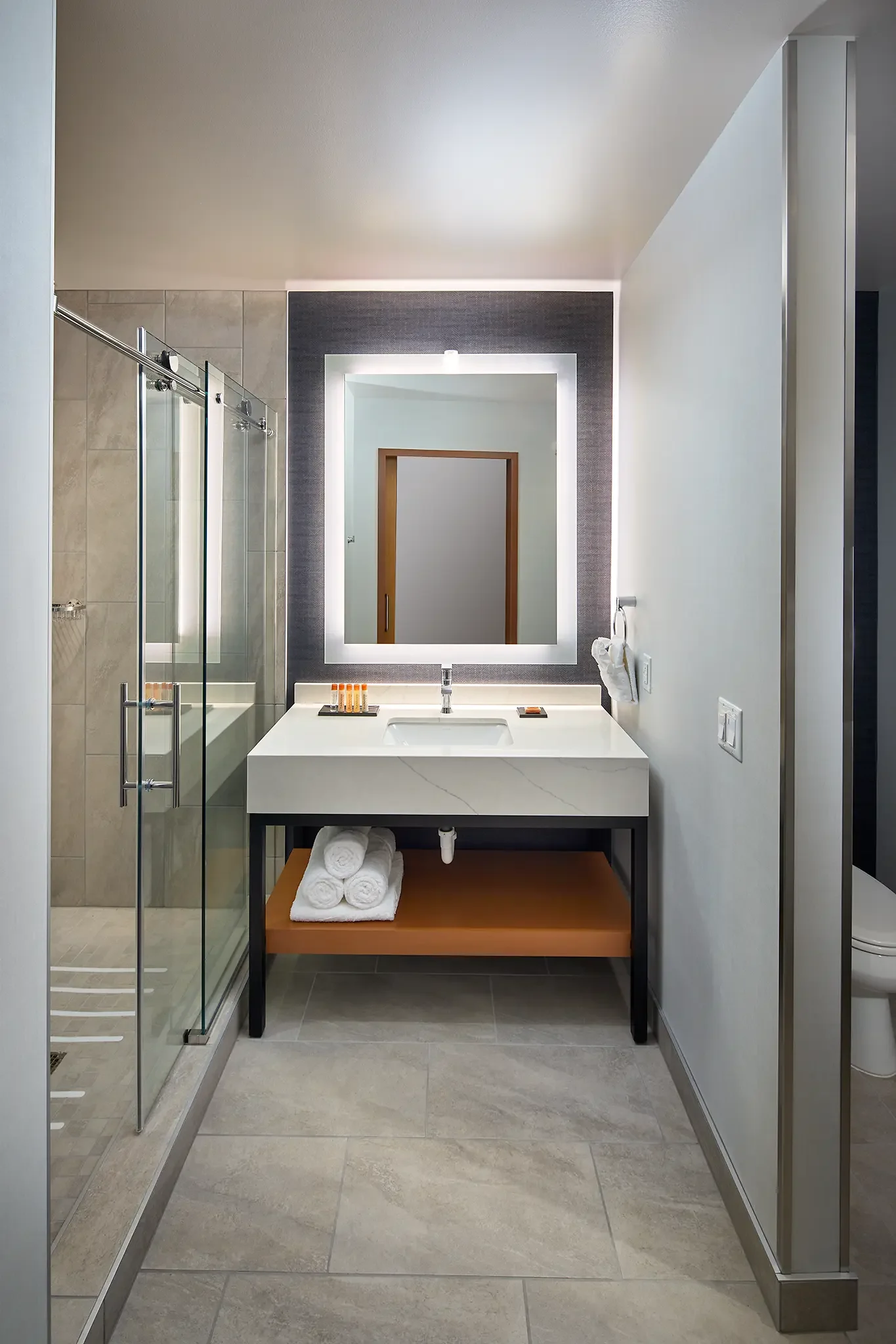 Architectural photograph of the luxurious bathroom inside a King Room suite at the Emerald Queen Casino Hotel, featuring modern fixtures and finishes.